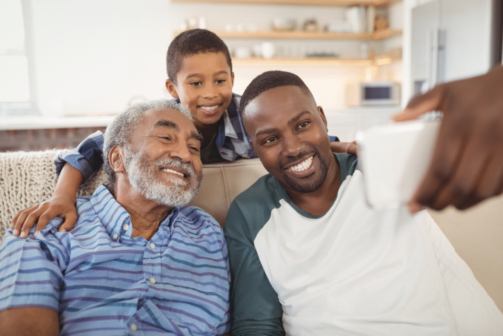 Three Generations Smiling Together – Father, Son, and Grandfather Bonding