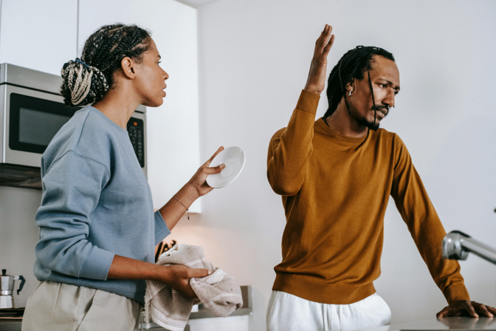 Couple arguing in the kitchen during a heated moment.